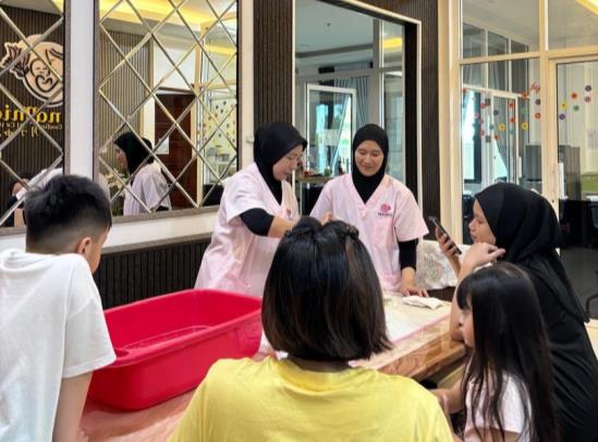 Staff assisting a parent and child